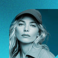 Young blonde media creative professional in a modern studio setting, working on branding visuals and digital content, representing a German language course for media, creative and luxury sectors, focused on international communication and professional positioning